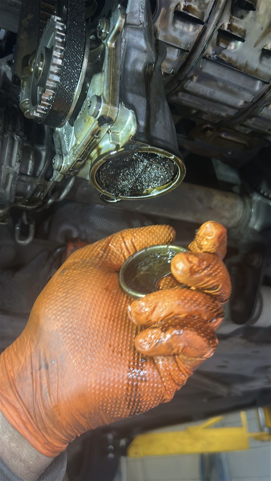Oil pickup removed from an engine, its strainer completely blocked with black wet belt sludge